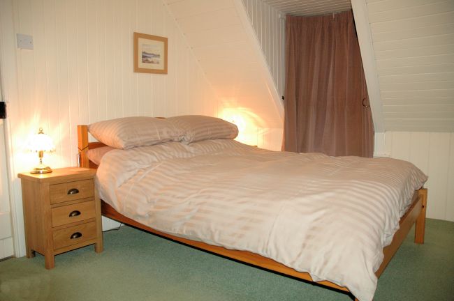 The bedrooms have pine-lined walls and ceilings and are cosy and welcoming. There are superb views from the bedroom windows.