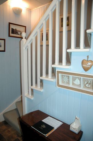 The front door of Bruaich Cottage in Lochcarron opens into the hallway from which there are doors to the kitchen/dining room, the living room and the bathroom. The hall, stairs and landing are pine-clad and tastefully decorated.